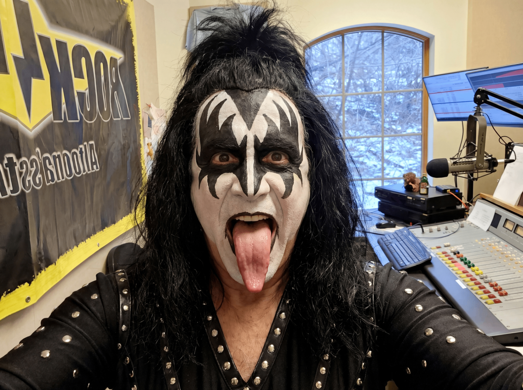 Dan in full Gene Simmons KISS makeup behind the radio board